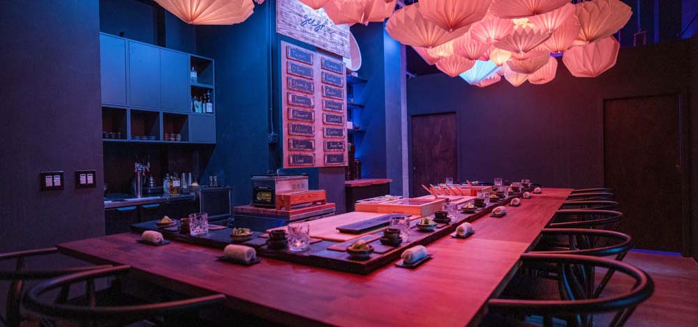 Inside view of a sushi restaurant with speakeasy vibes.