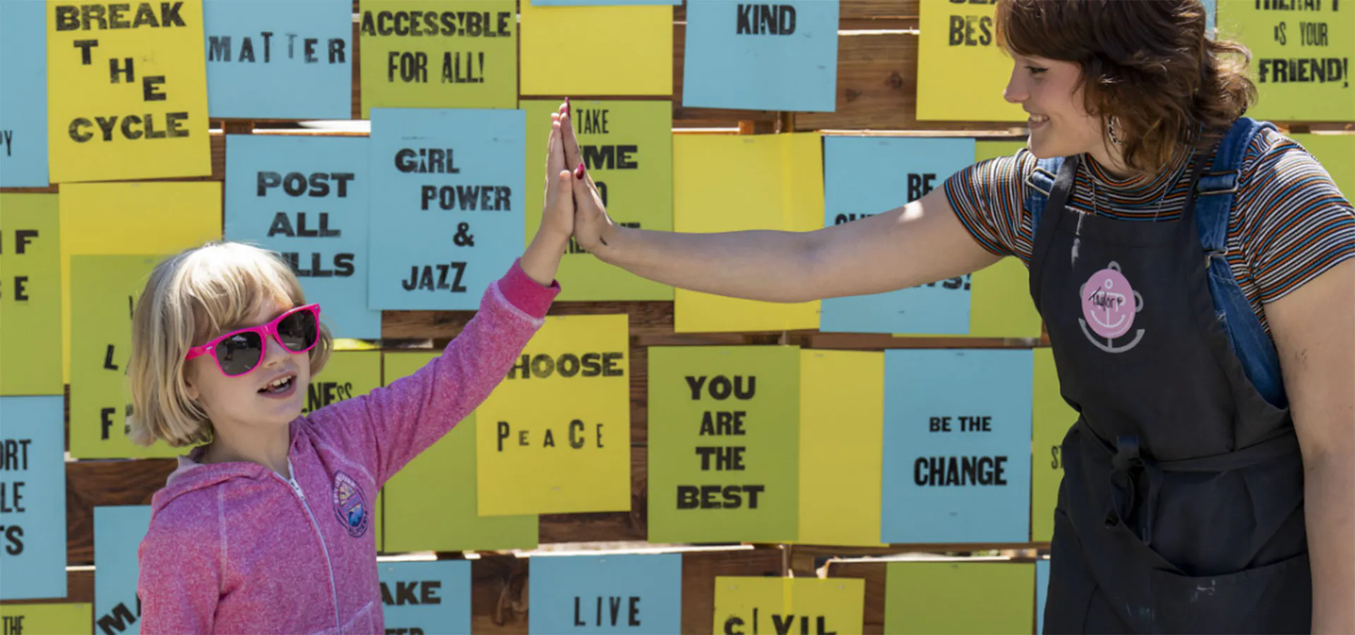 woman and girl high fiving
