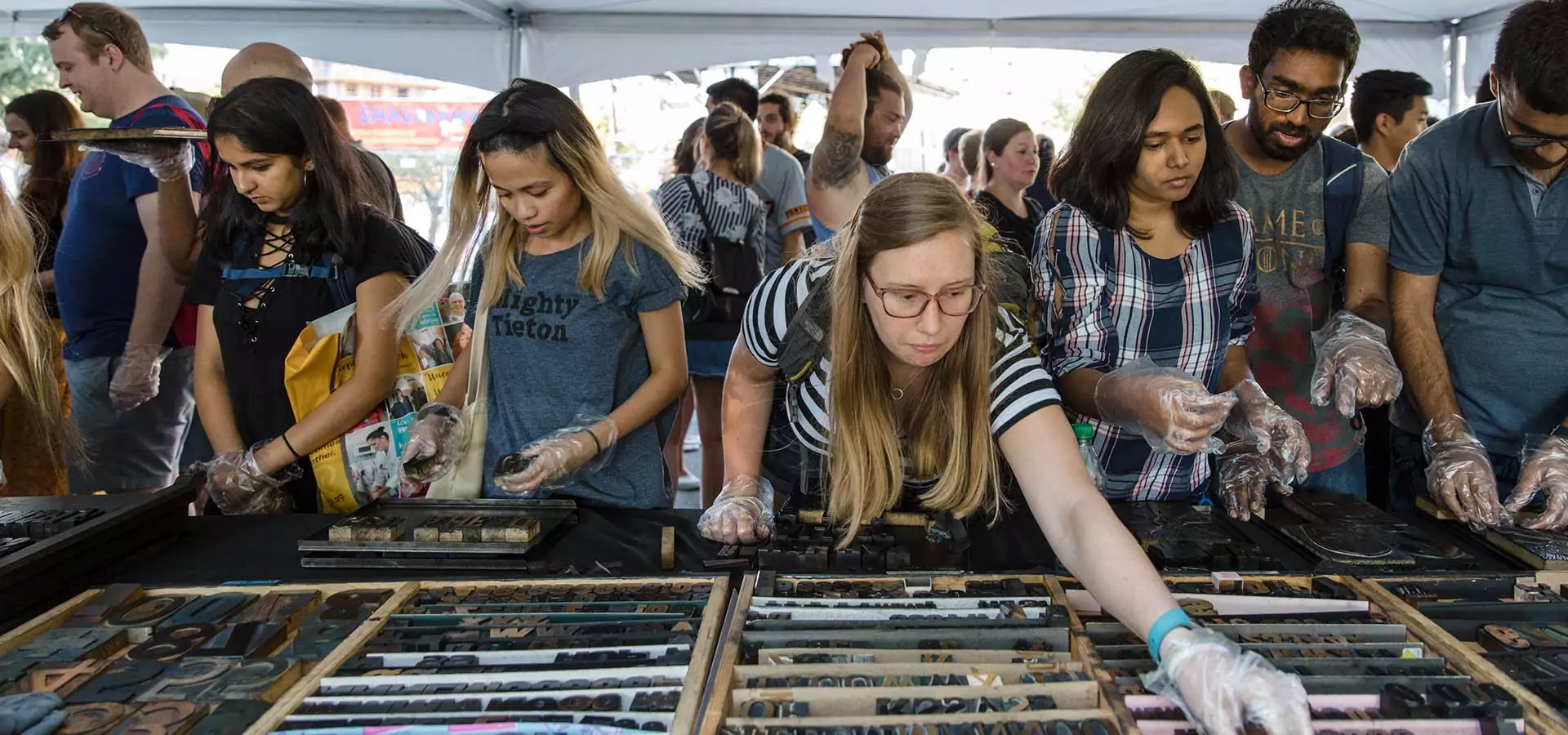 People selecting letter press blocks.