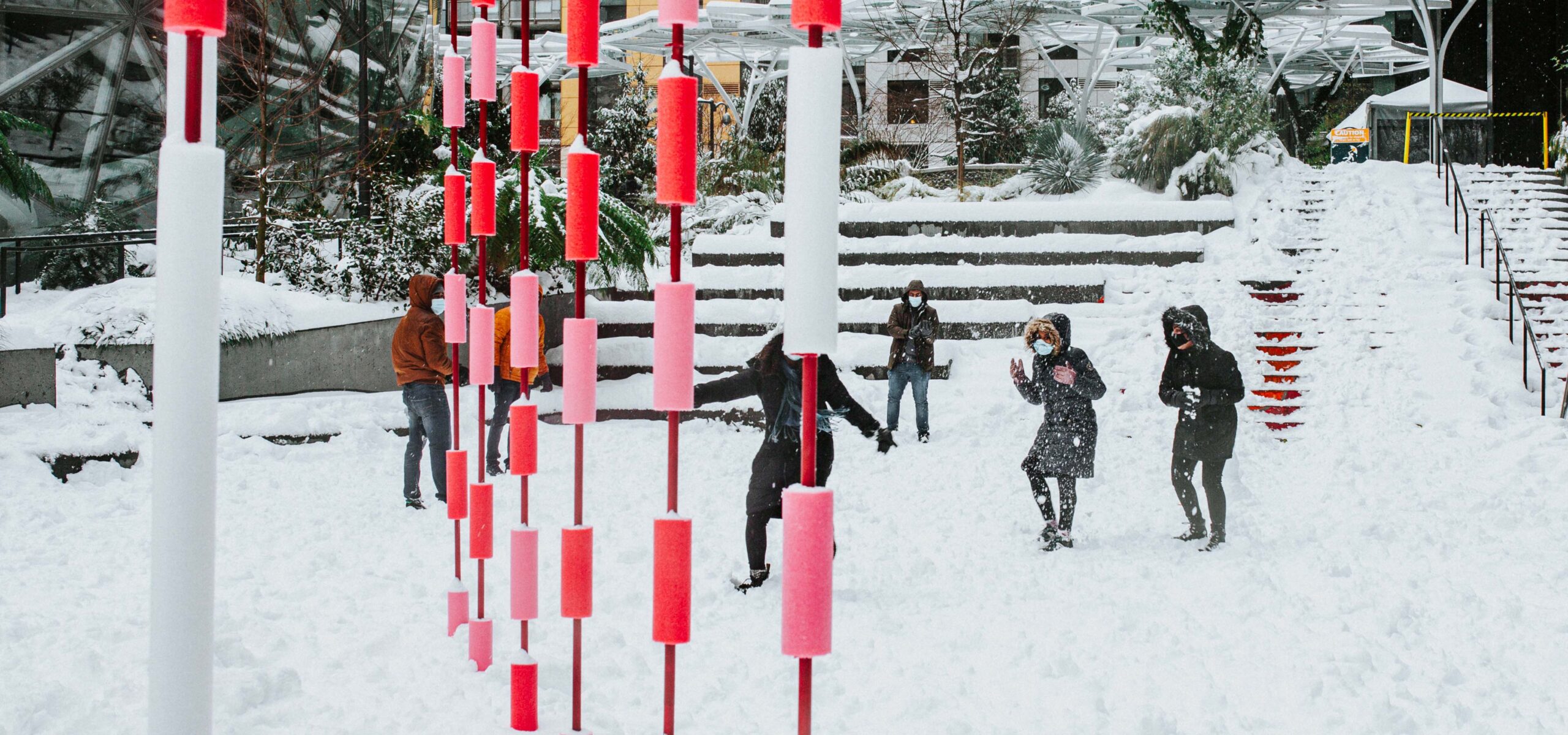 People playing in a snowy plaza during Valentine's Day.