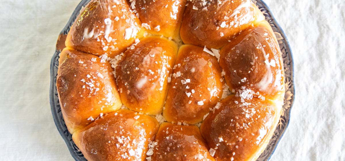 Round pan filled with salted dinner rolls.