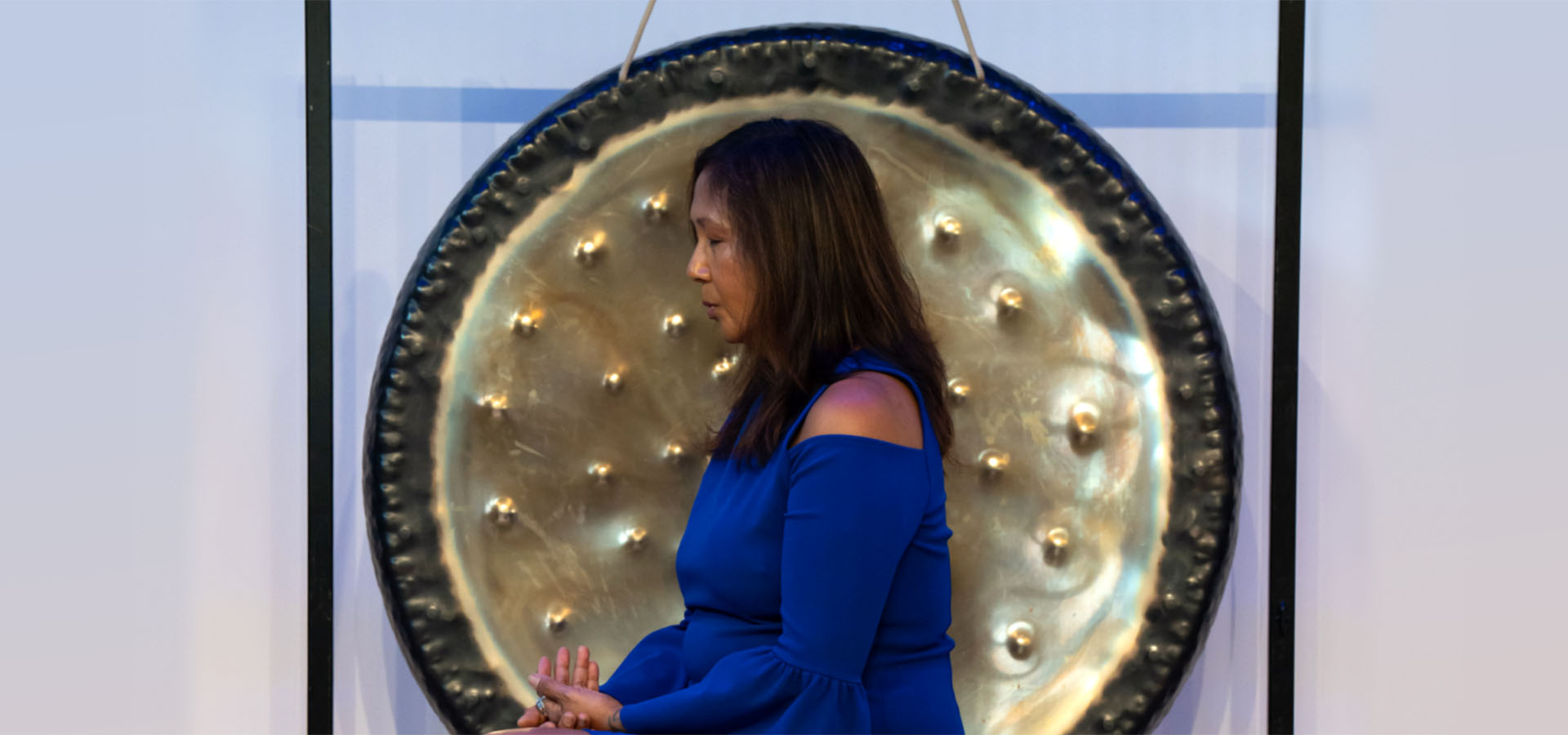 woman sitting in front of gong