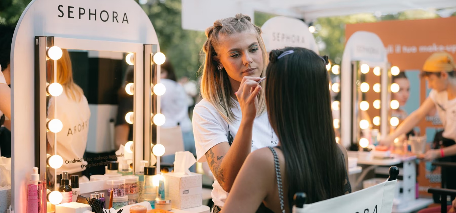 woman applying makeup to client