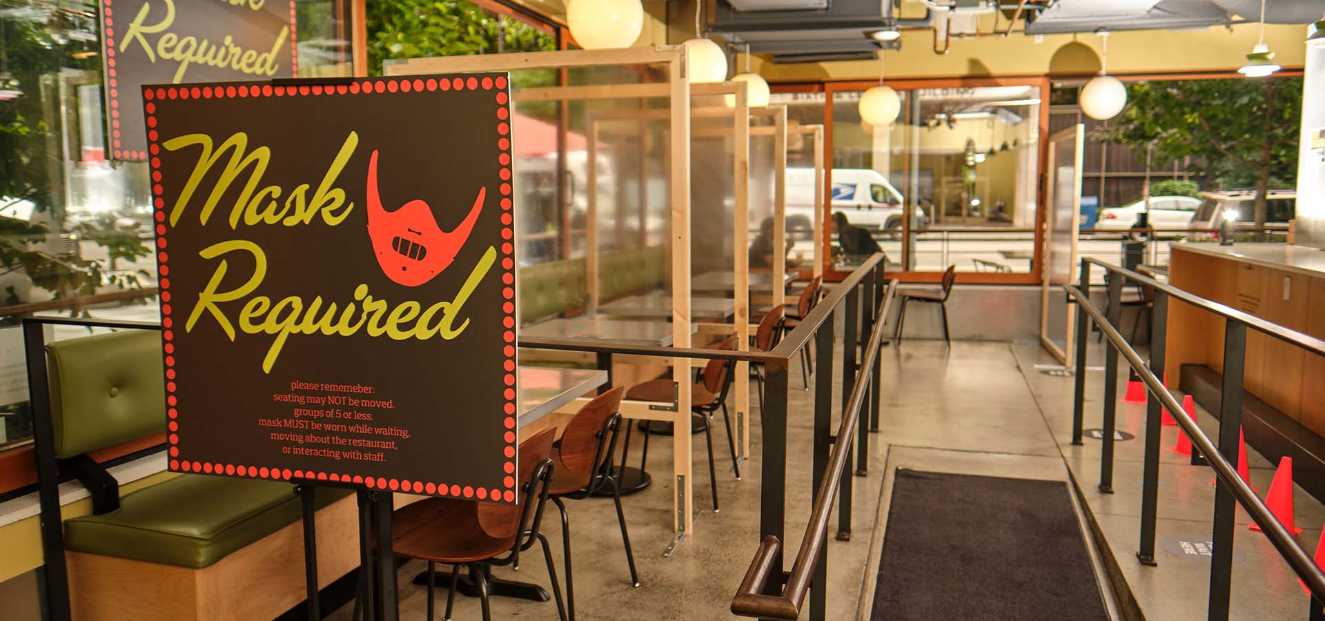 Interior of the Skillet restaurant with hostess sign indicating you must wear a mask.