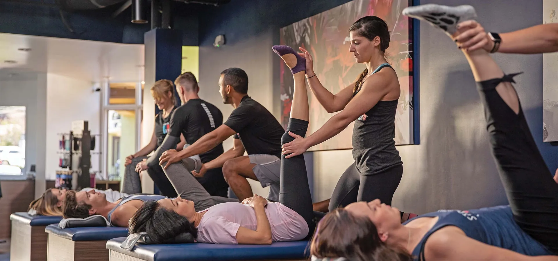 people stretching people's legs