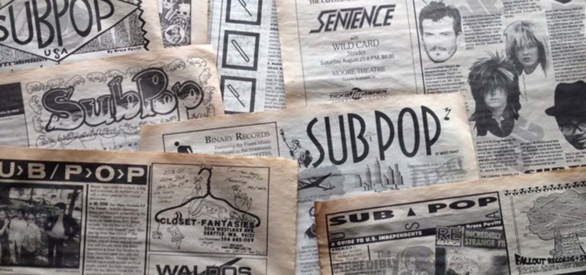 Newspaper pages with the SubPop logo and stories