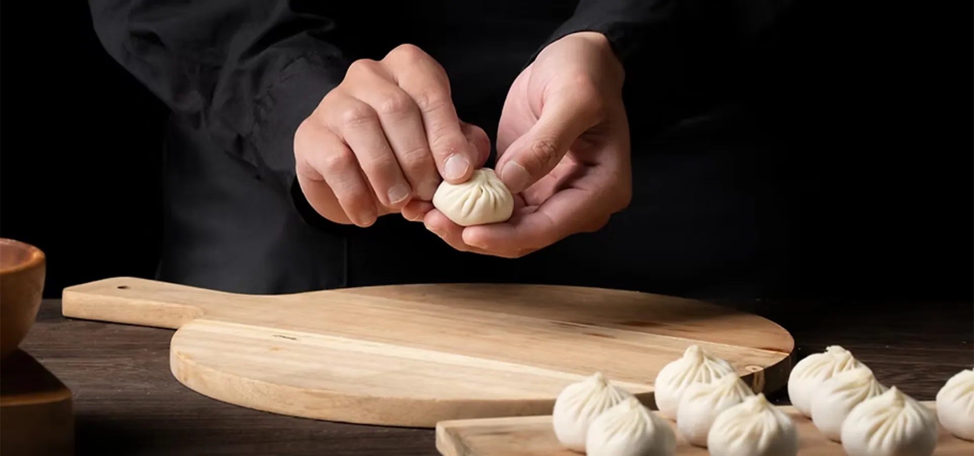 hands making dumplings
