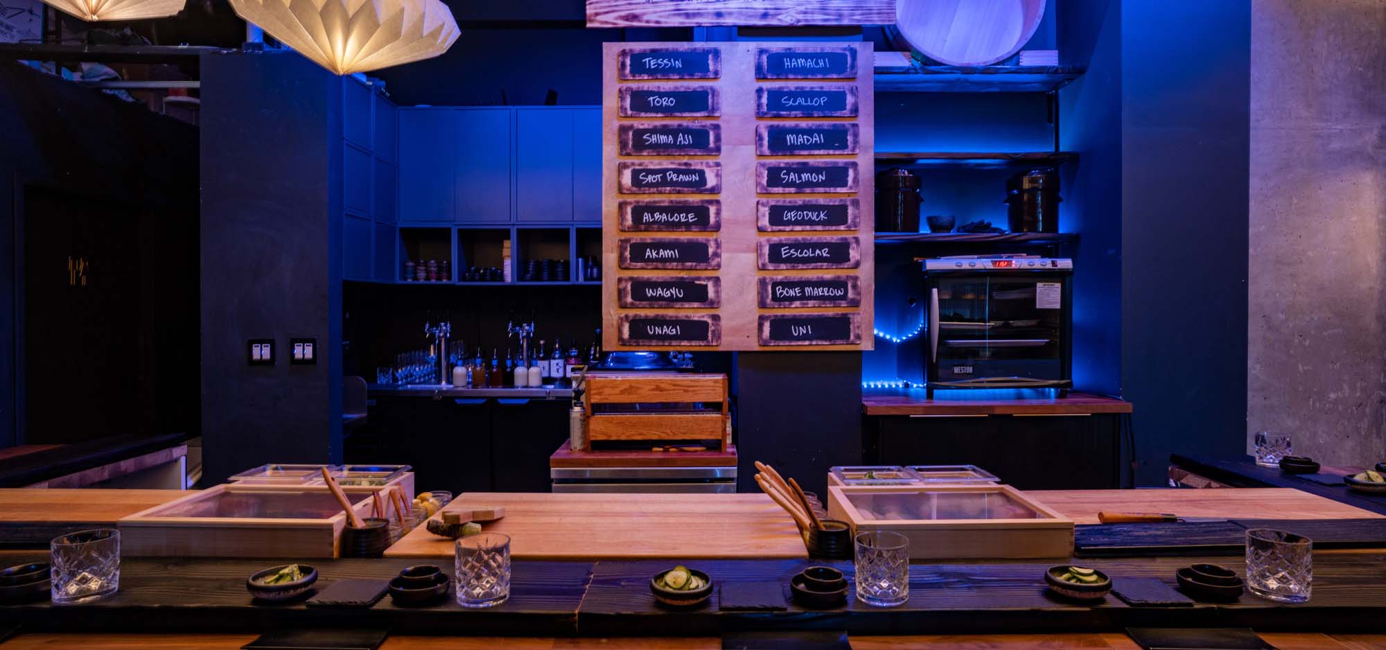 Inside an exclusive sushi restaurant with dimmed lights.