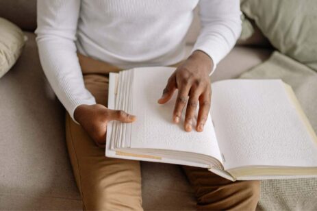 Man reading a book in braille.
