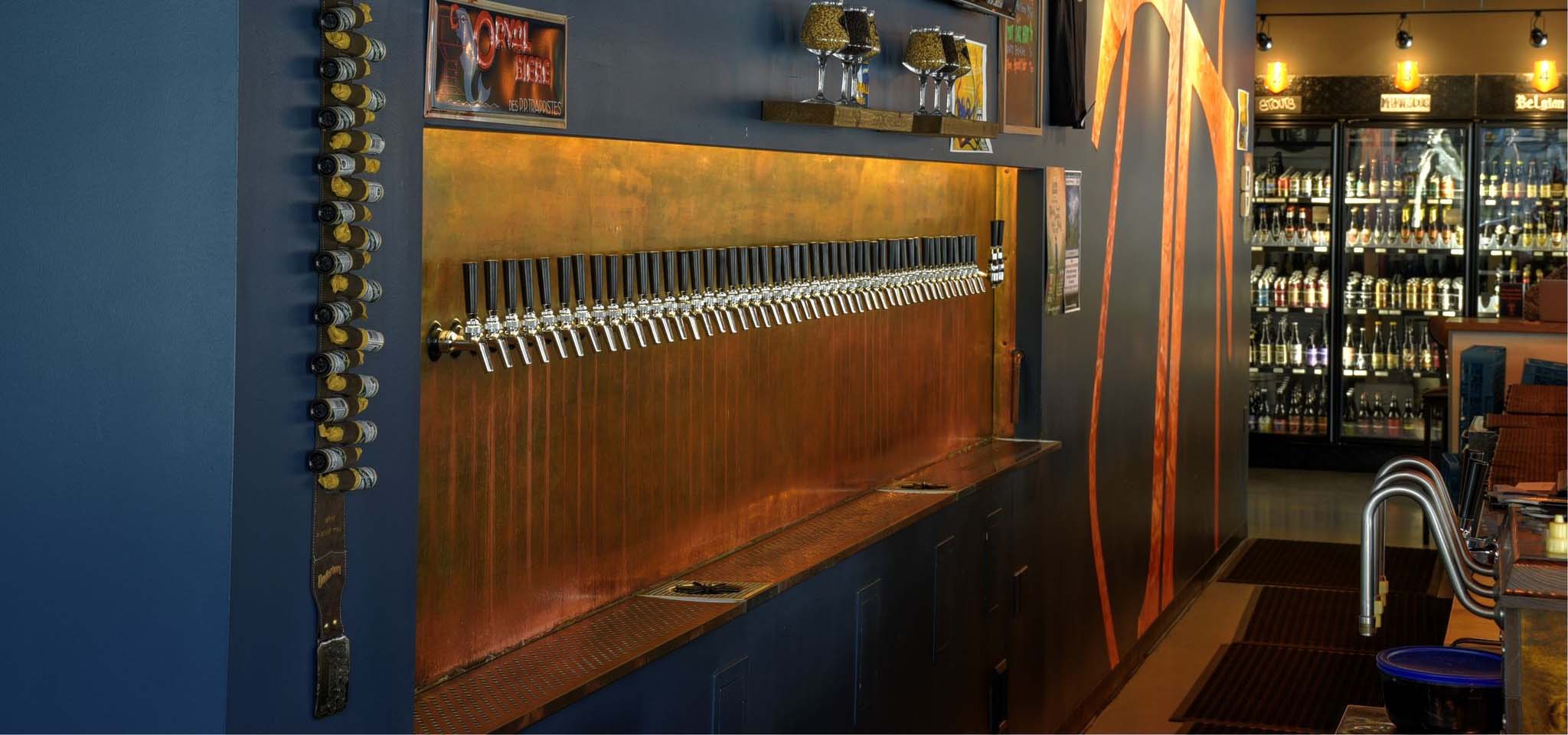 Beer taps in a row at a bar.