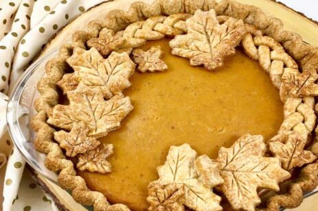 Fancy pumpkin pie with crust leaves.