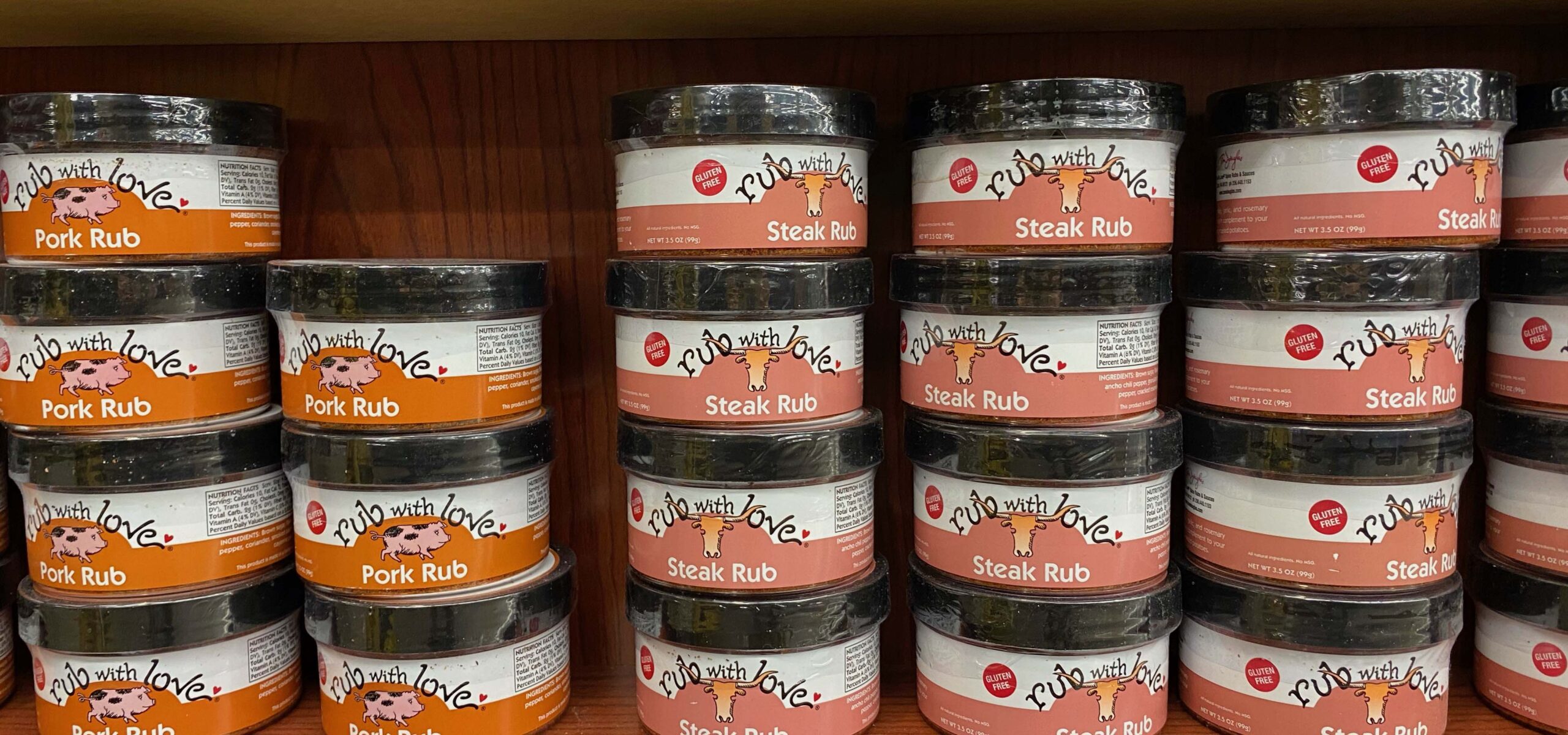 Stacks of spices and rubs on a store shelf.