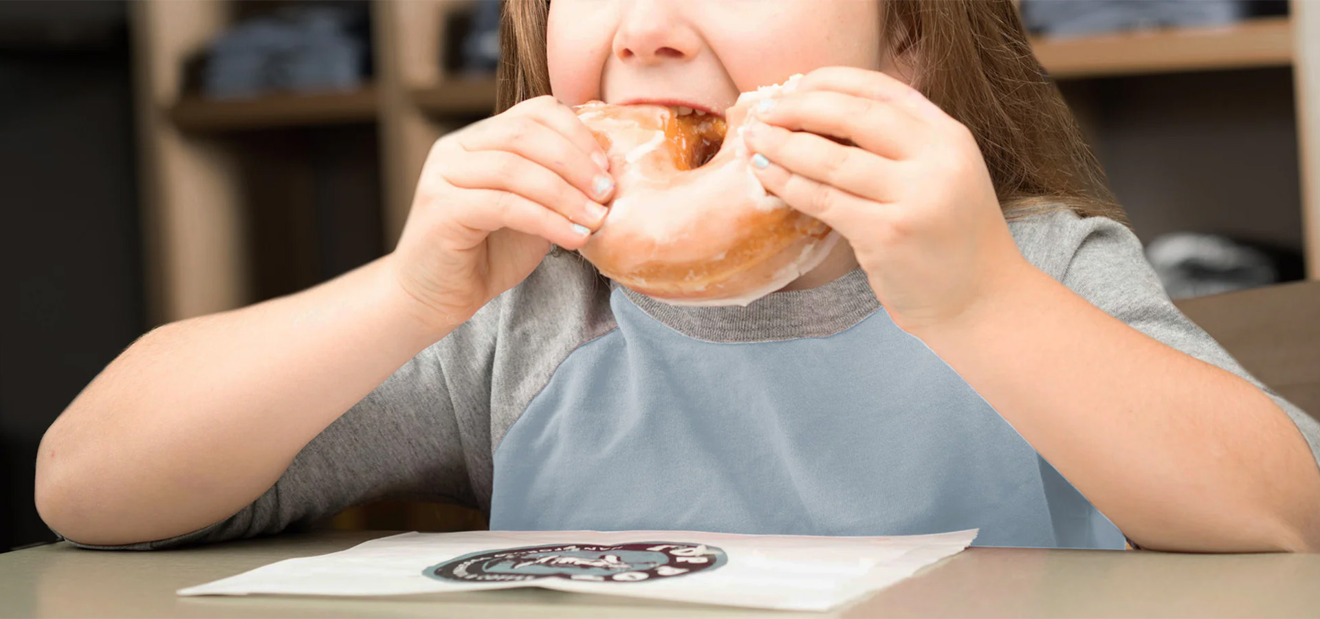 child eating doughnut
