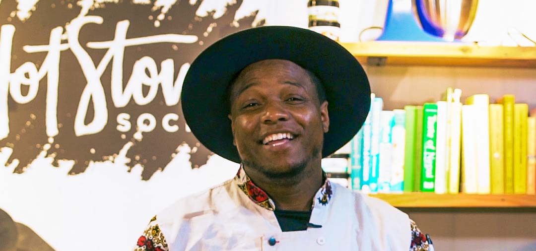 Portrait photograph of Chef Trey Lamont in a kitchen.