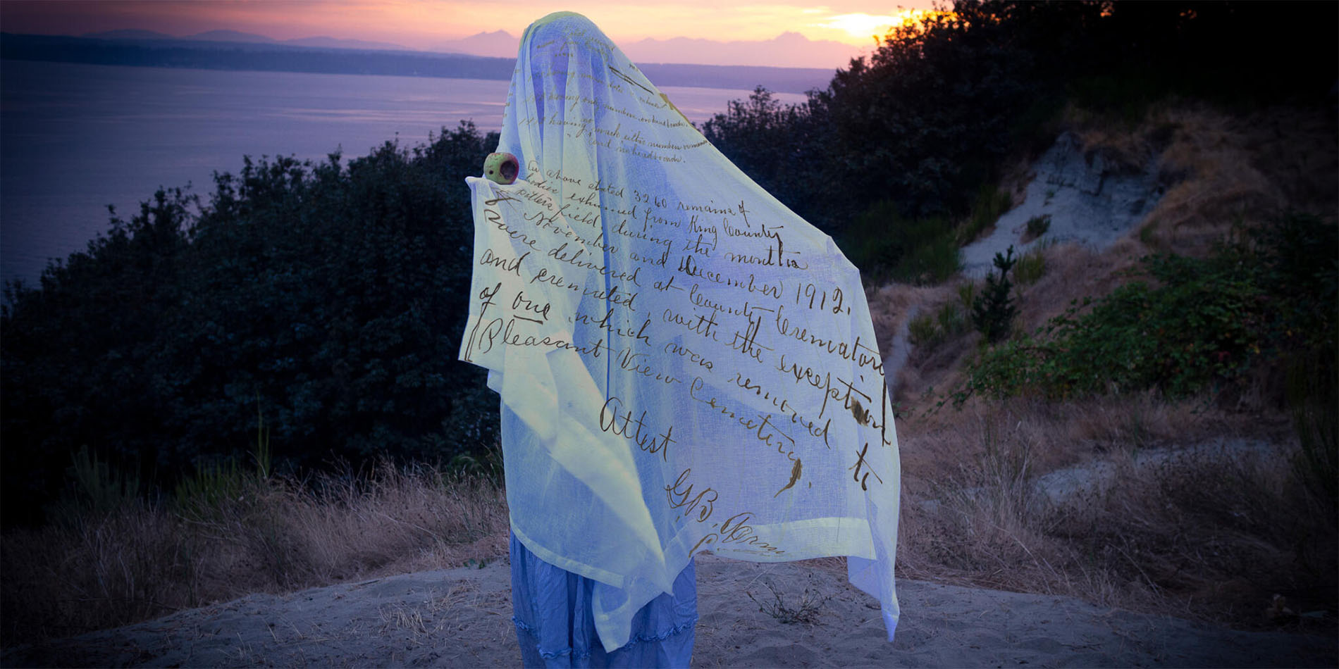 person draped in cloth with writing