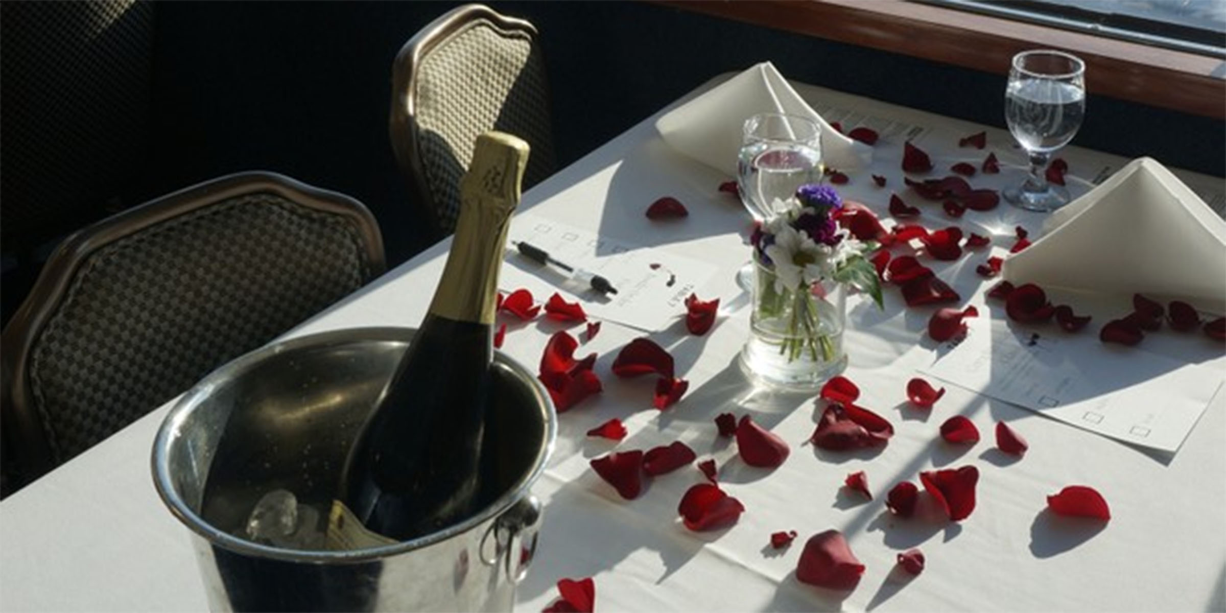 table with champagne and rose petals
