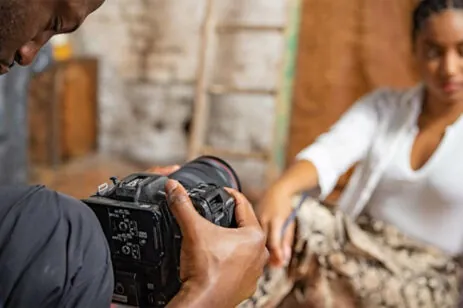 man filming woman
