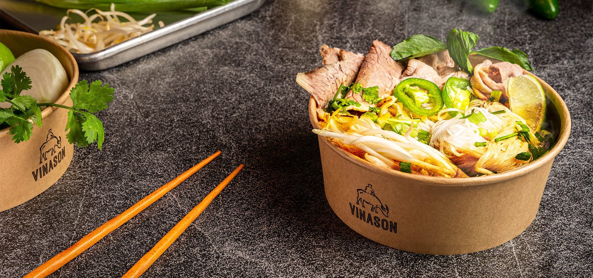 bowl of pho with company logo