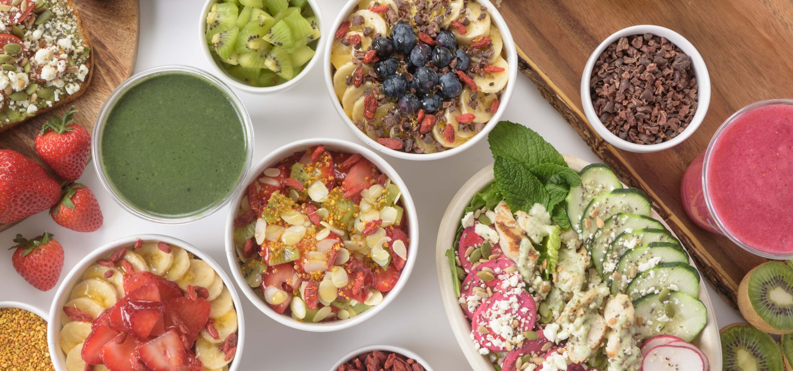 Table spread of healthy fruit and vegetable bowls.