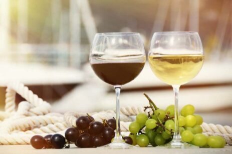 Two glasses of wine and grapes.