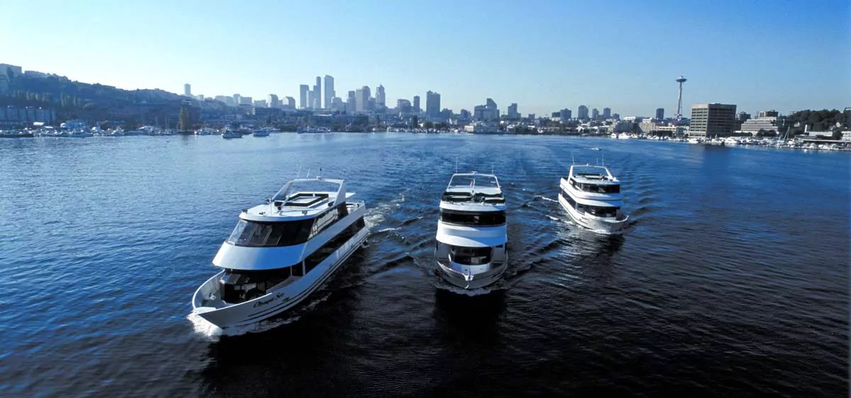 Three cruise ships sailing together on South Lake Union, Seattle.