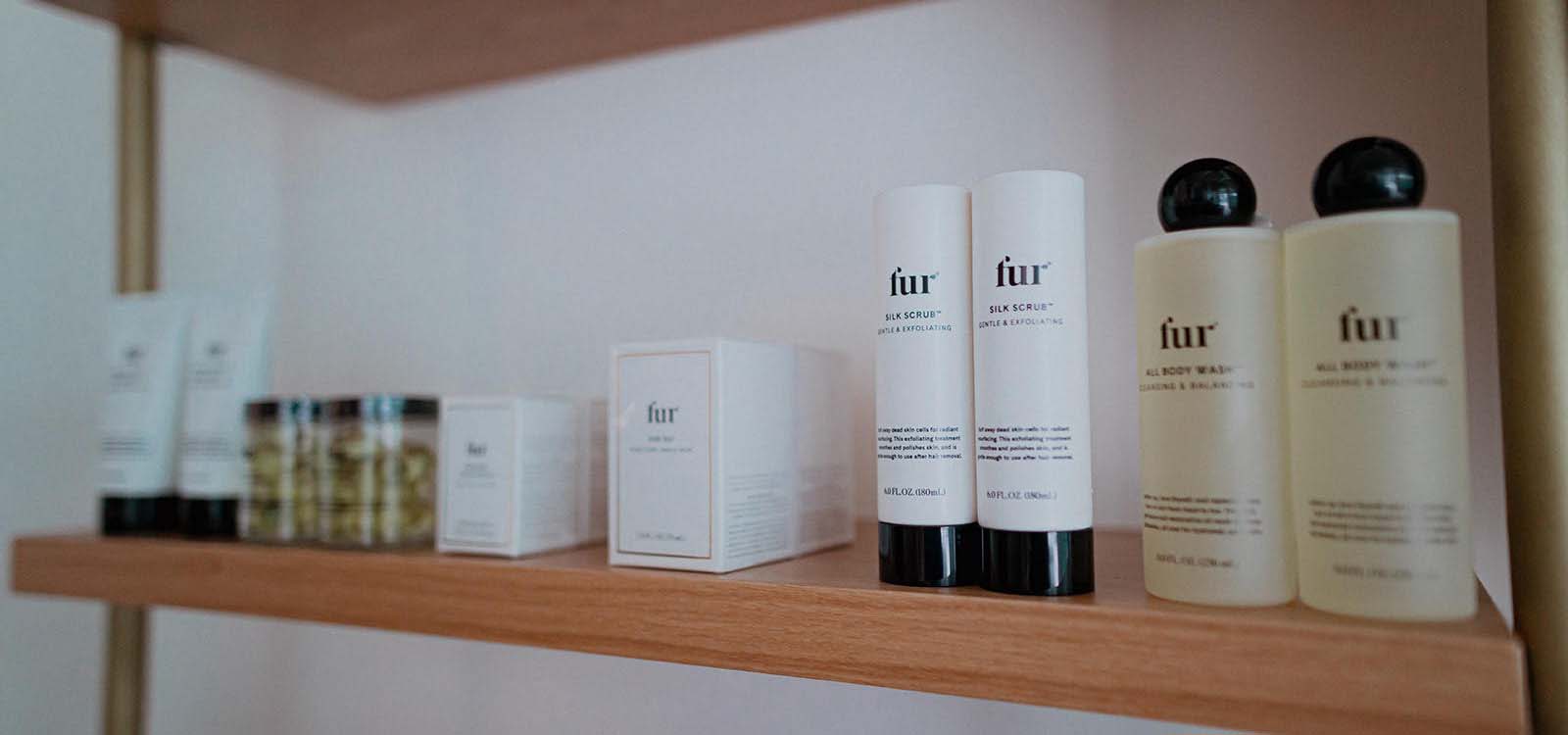 Salon shelf with beauty products in rows.