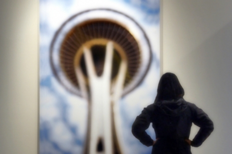 person looking at image of Space Needle