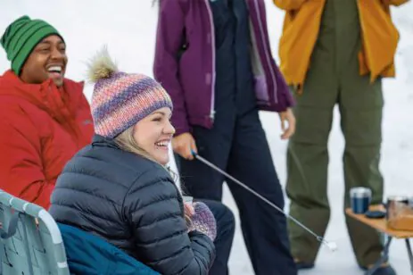 people roasting marshmallows in snow