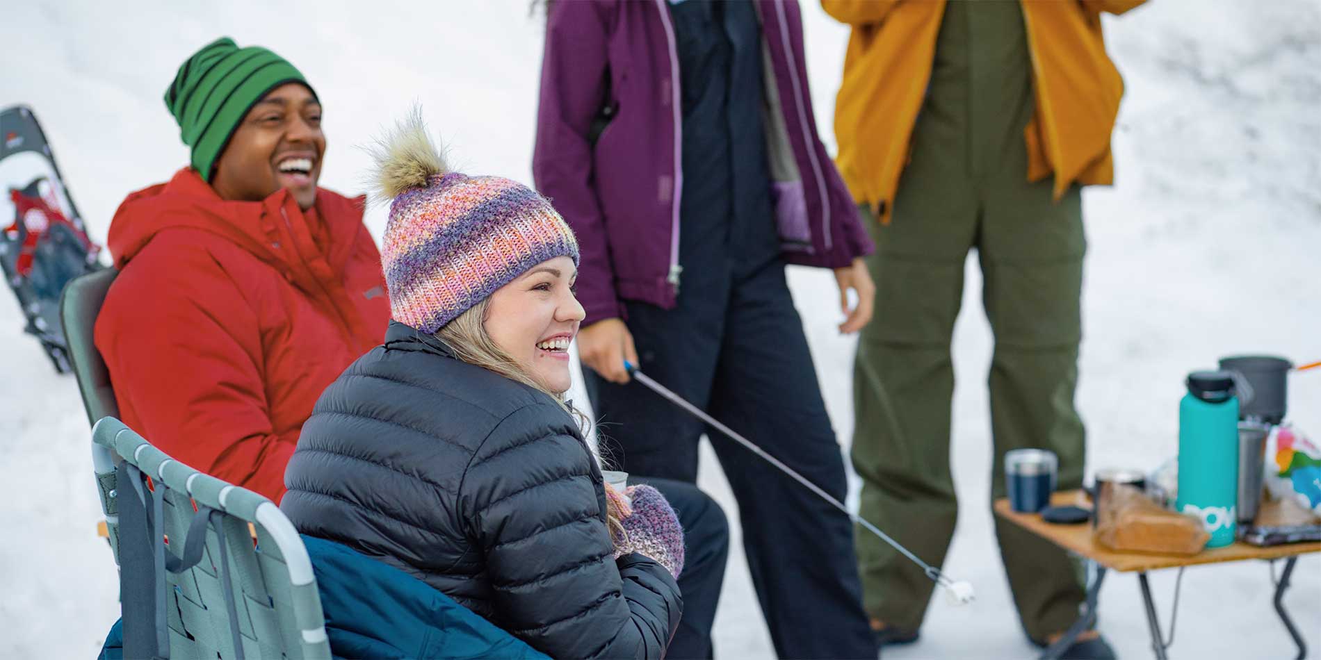 people roasting marshmallows in snow
