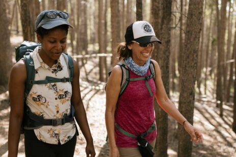 two women walking in woods