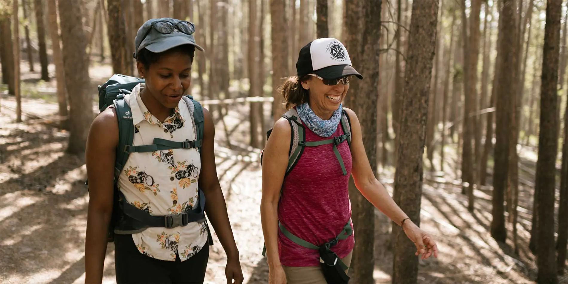 two women walking in woods