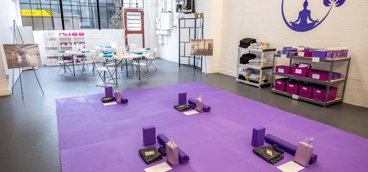 Image of a yoga studio with a purple floor.