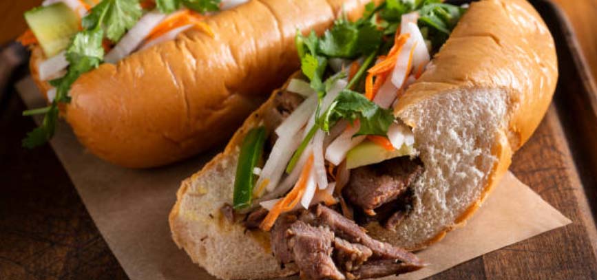 Close up of a banh mi sandwich cut in half.