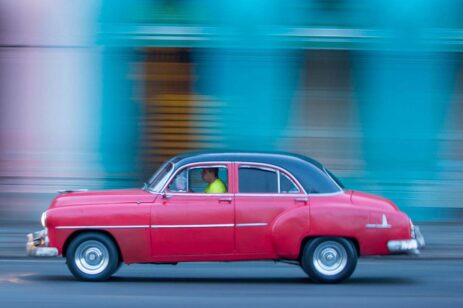 A red car driving.