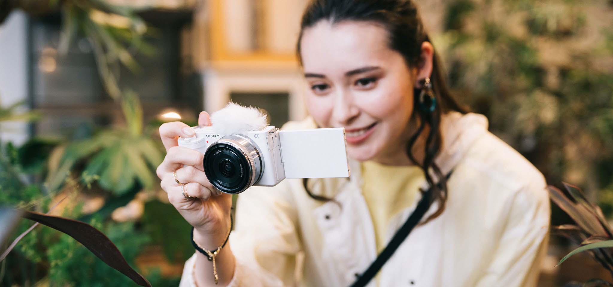 Woman looking at an image on her camera screen.