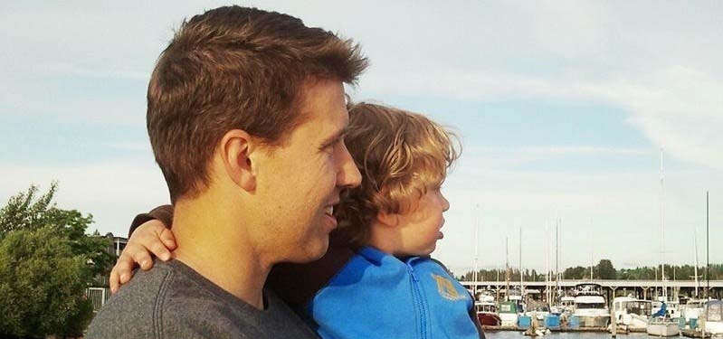 Father and son looking at a lake.