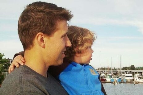 Father and son looking at a lake.