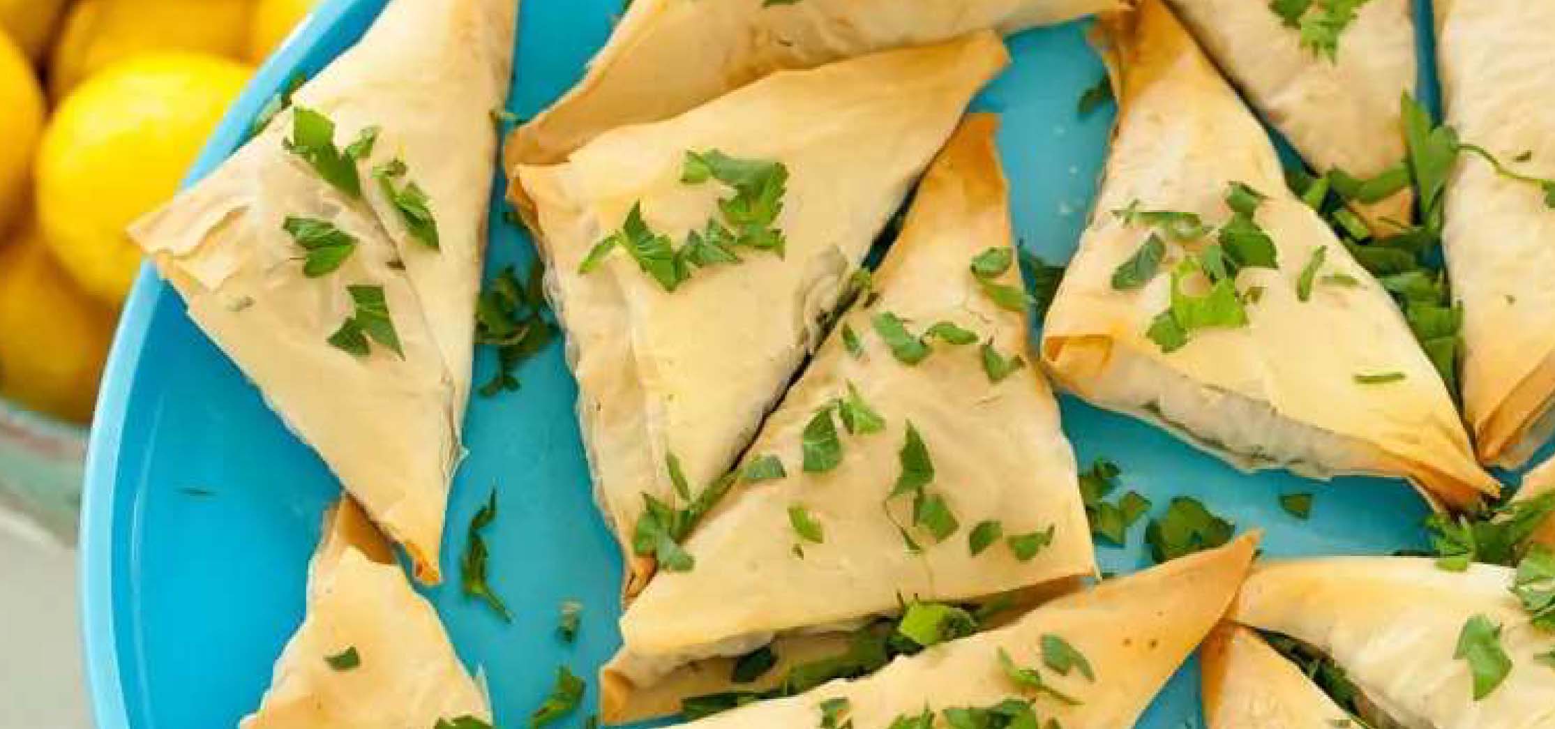 Blue plate of Spanikopita and Tzatziki.