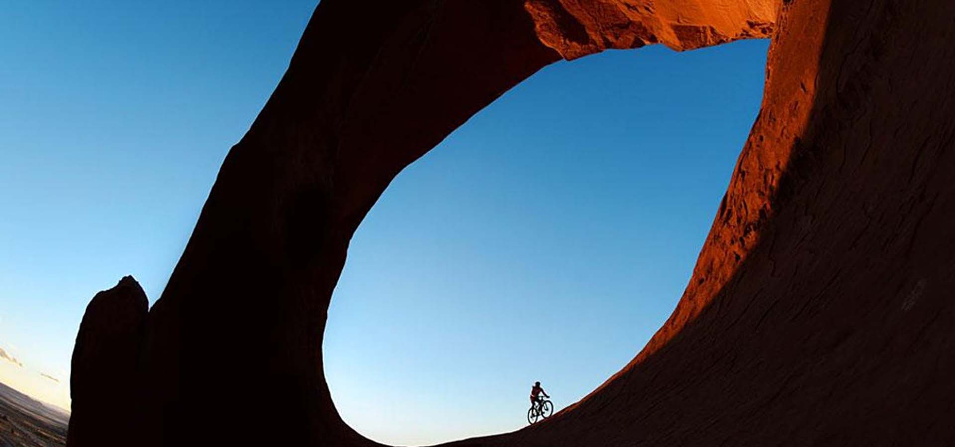 Bike rider riding through a geographical archway