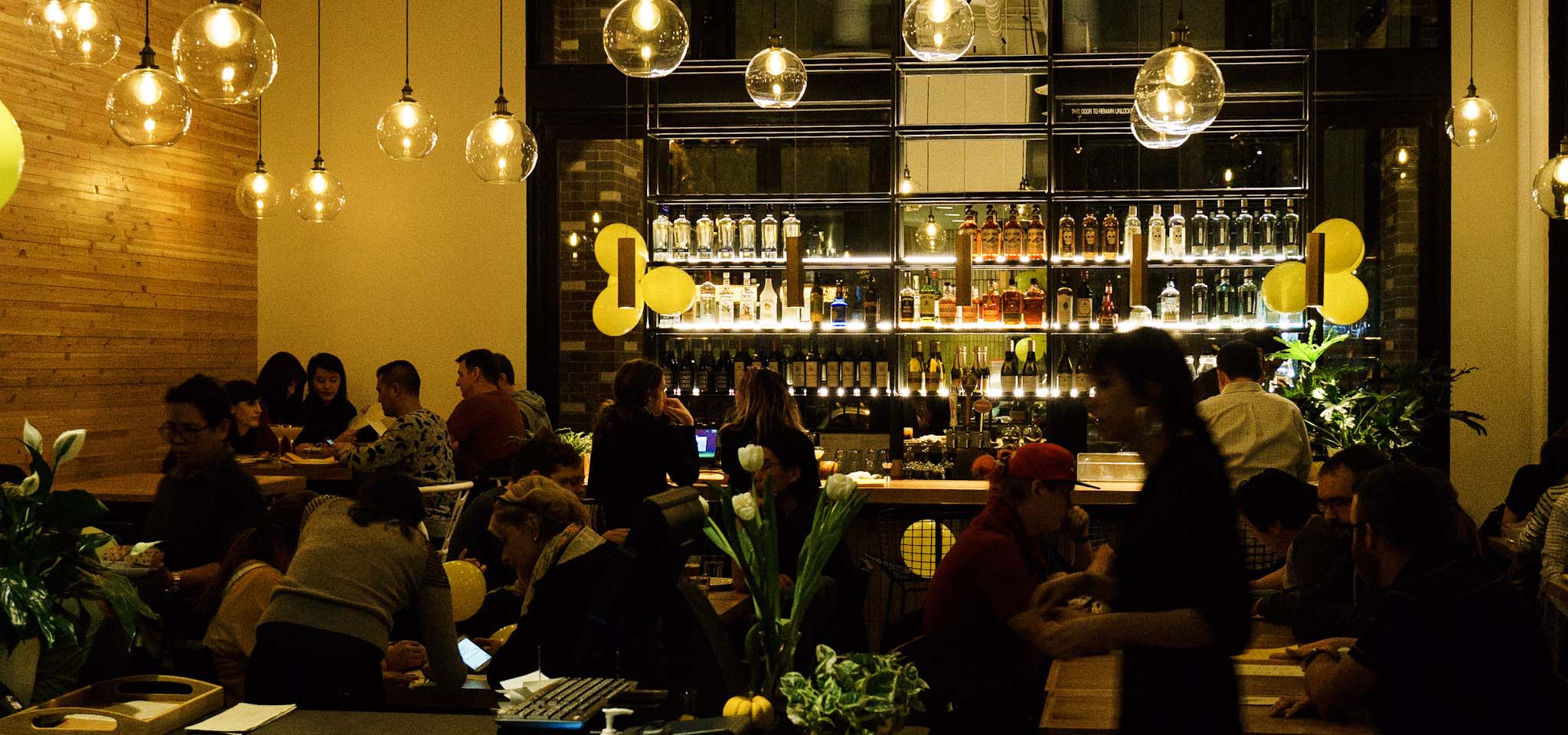 Busy night time dinner crowd at a Thai restaurant.