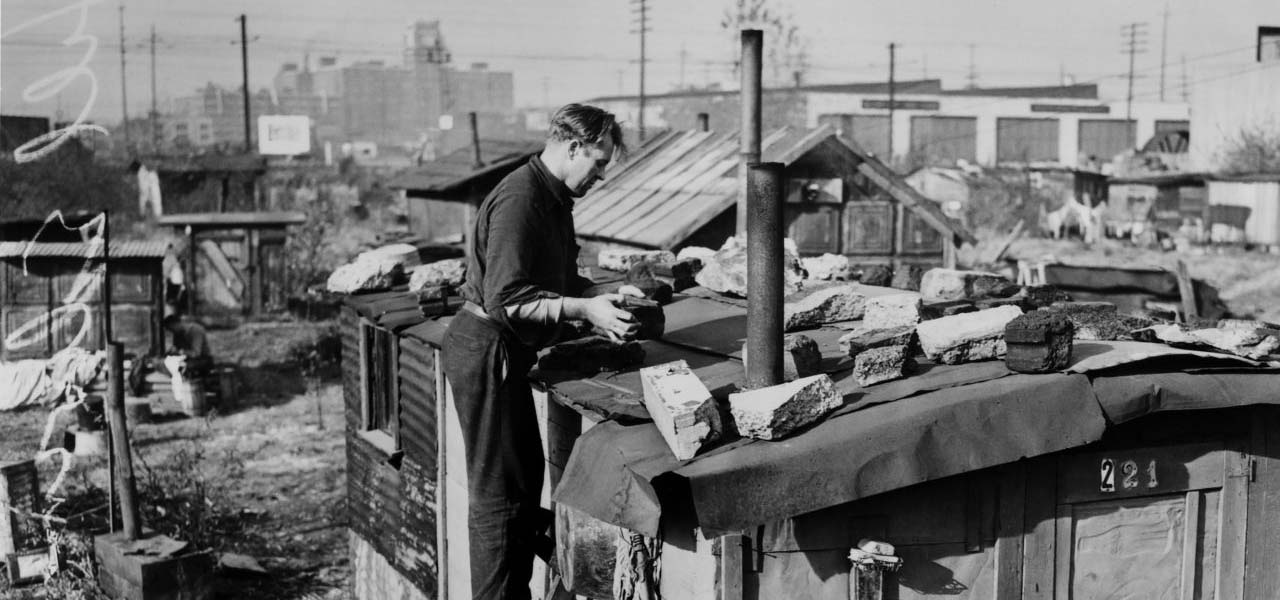 Man putting stones on his roof during the Dust Bowl times.