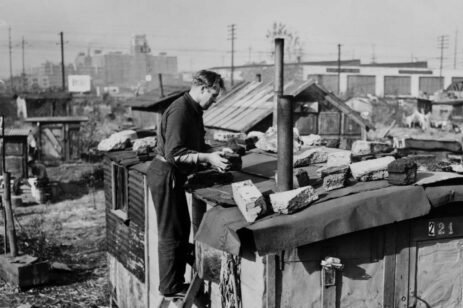 Man putting stones on his roof during the Dust Bowl times.