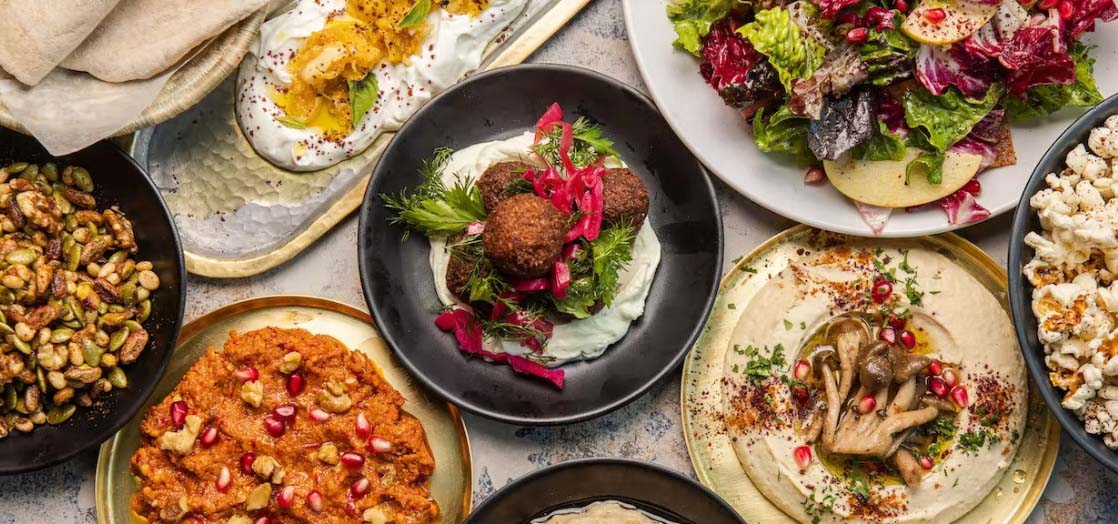 Table spread of Mediterranean dishes.