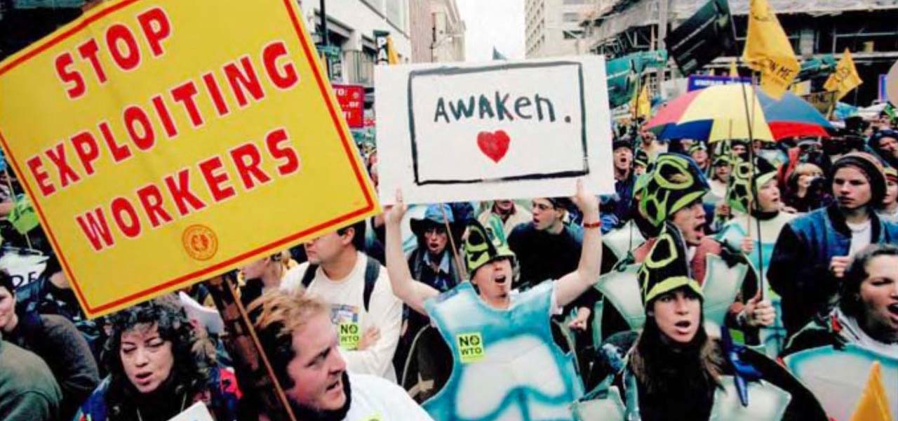 Protesters marching and holding signs for workers rights.