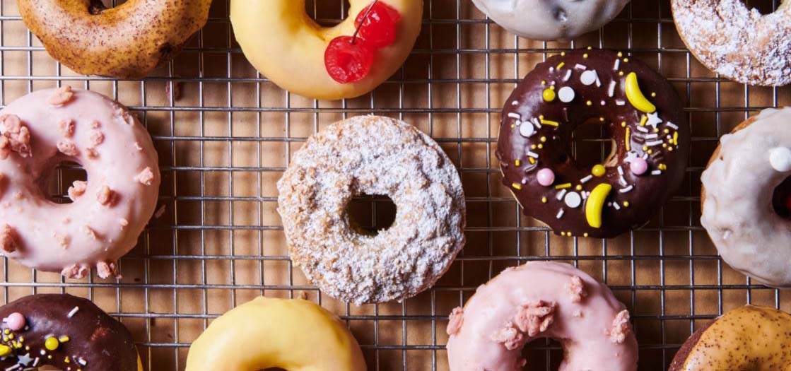 Cooling rack of colorful mochi donuts.