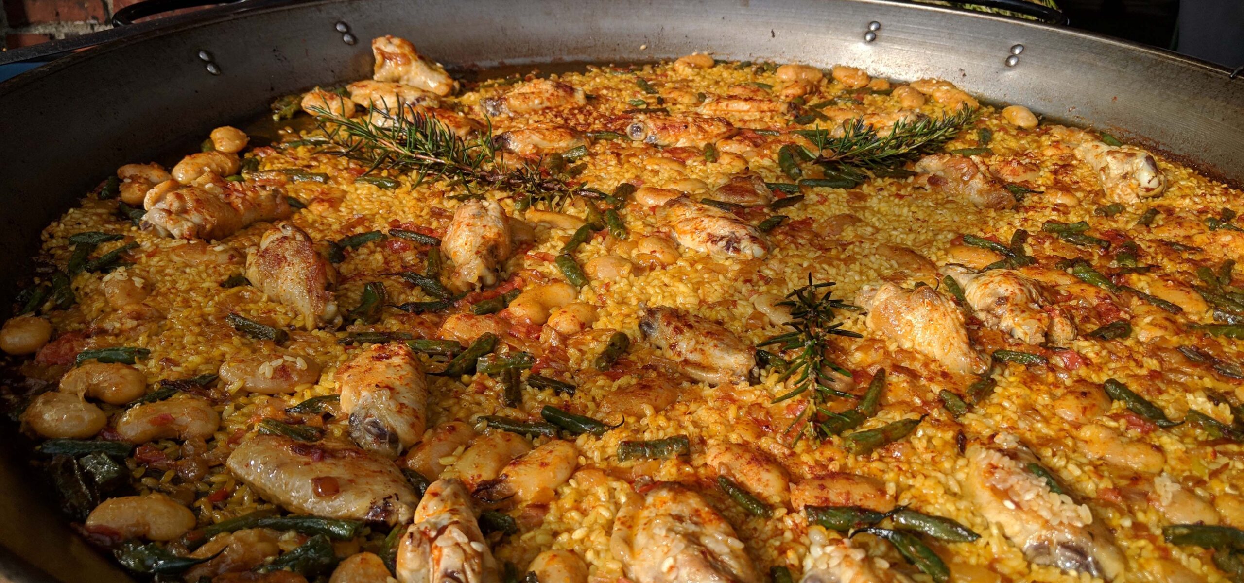 Large pan of chicken paella.