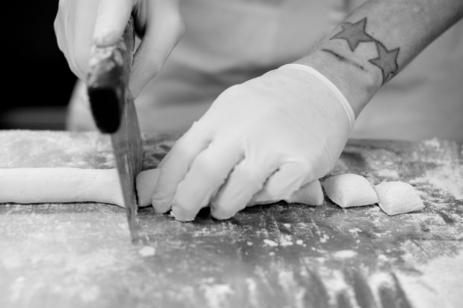 Image of chef cutting pasta