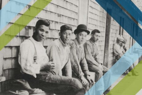 Old photo of Asian workers on a bench.