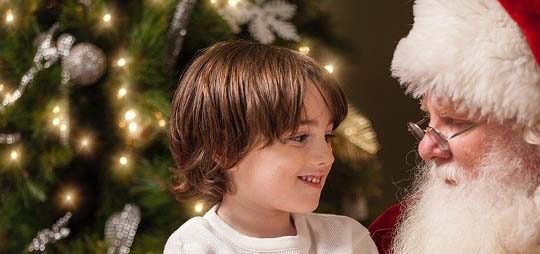 A boy sitting on Santa's lap.