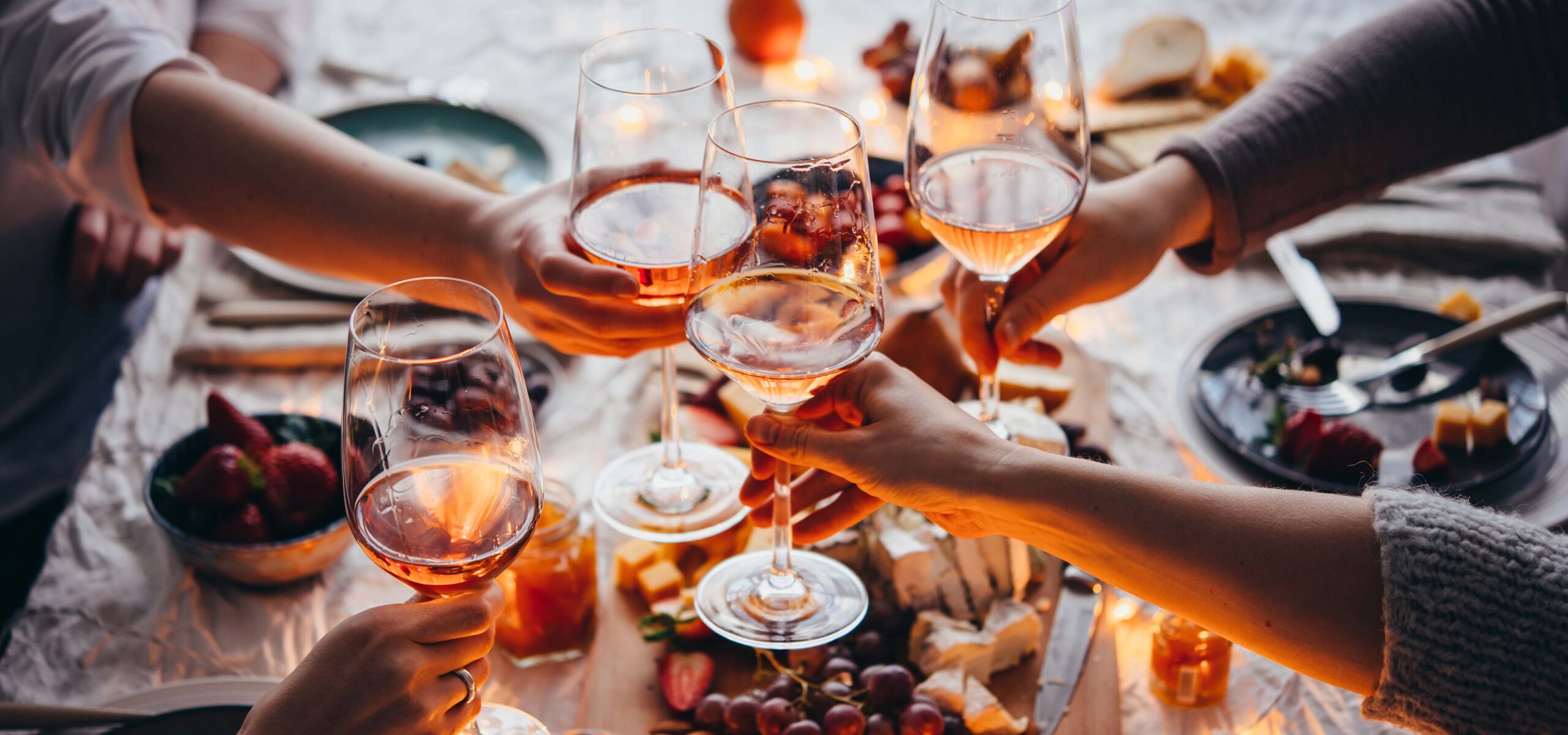 People toasting glasses of wine.